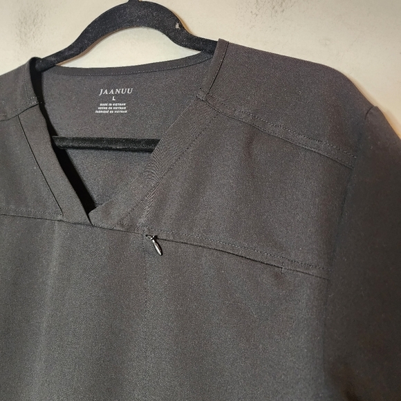 Jaanuu black scrub top. 1 zip chest pocket.  Short sleeve v-neck. Women's size L - Picture 5 of 14